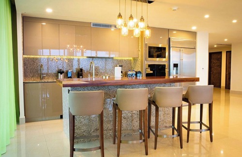 Playa Mujeres Resort | 3 Bedroom Ocean View with furnished balcony and hot tub along with hammocks.