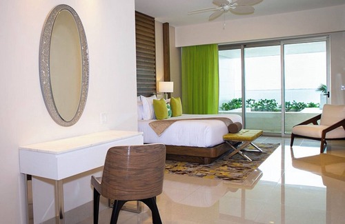 Playa Mujeres Resort | 3 Bedroom Ocean View with furnished balcony and hot tub along with hammocks.