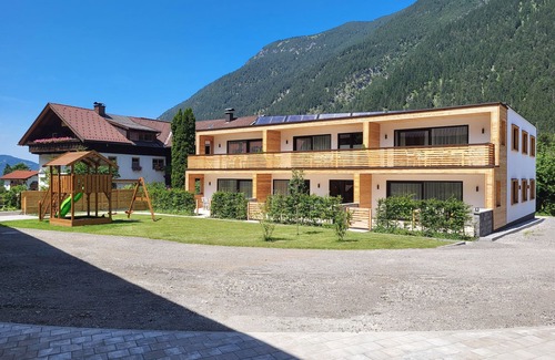 Bichlbach Apartment | 50m² modern holiday apartment with balcony, free swimming lake, 100 m from the ski area