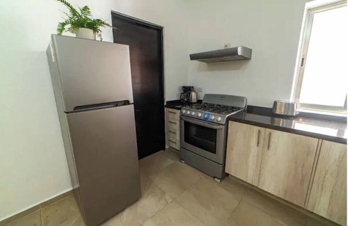 Alfredo V. Bonfil Apartment | Airport condo w/KING BED pool, security, kids game park + bbq area with lounge!