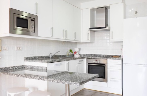 Poris de Abona Apartment | Apartment on the beach, work area and private parking - PillowAbroad