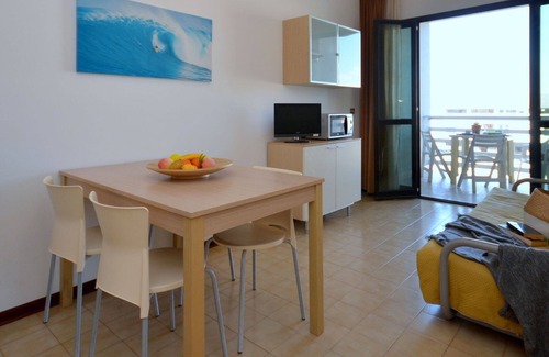 Lignano Sabbiadoro Apartment | Beautiful apartment for 4 people with pool, A/C, TV, terrace, pets allowed and parking