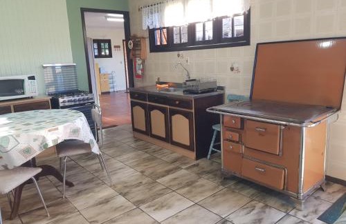 Cambara do Sul House | Casa a 300m da Praça, Completa, Wi-Fi, 130m quadrados, 4 Camas de Casal, 4 Quartos, Até 11 Pessoas, Quintal com Vasta Área Verde, Varanda nos Fundos, Garagem Coberta 1 Carro, Estacionamento Interno 2 Carros, Churrasqueira, Fogão a Lenha