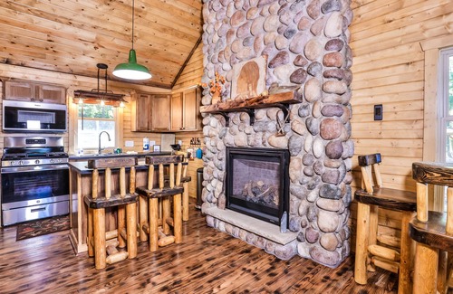 Eagle River Cabin | Charming, lakefront home with a gas fireplace, docks, firepit, & full kitchen
