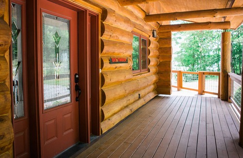 Magnet Cabin | Come sit, relax and unwind on the covered wraparound deck along the River.