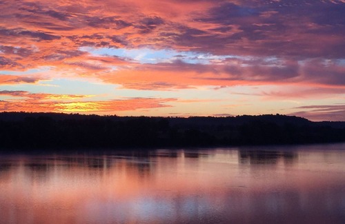 Magnet Cabin | Come sit, relax and unwind on the covered wraparound deck along the River.