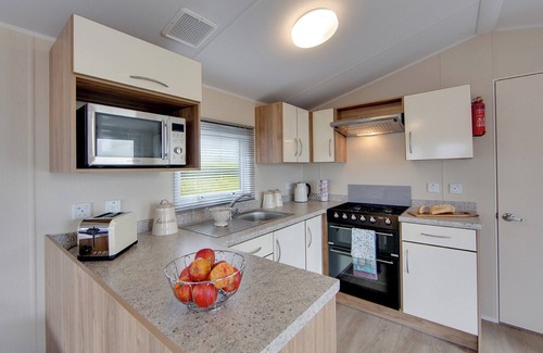 Kilwinning House | Contemporary caravan with one double with TV, and two twin.