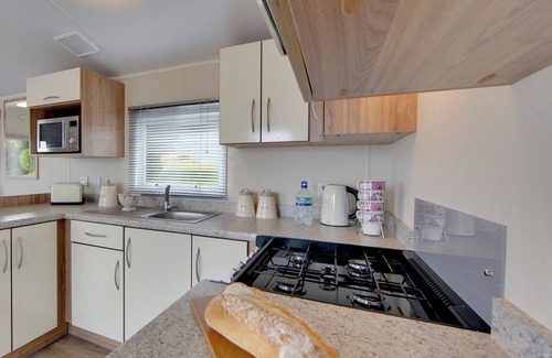 Kilwinning House | Contemporary caravan with one double with TV, and two twin.