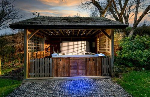Widegates House | Corn Barn at East Trenean Farm -Luxury Cornish Barn Conversion sleeping 8 with hot tub, private garden, rural views and EV facilities