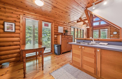 Lion's Head Cabin | Disconnect from it all at Stonewood, a cozy log chalet nestled in cedar forest on Georgian Bay. Enjoy a private shoreline, wraparound deck, wood stove, and access to kayaks, and trails. Peace, comfort, and adventure await in Cape Chin South.