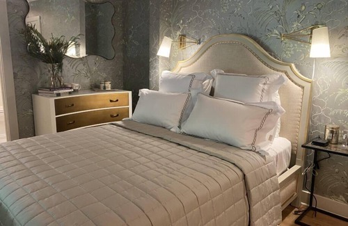 Lenox Bed & Breakfast | Elegant Carriage House room with a queen bed and private patio.