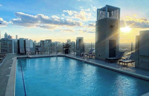 Midtown Apartment | Experience luxury at Royal Escape Midtown, perfectly located for relaxation and adventure. Minutes from top attractions, dining, and corporations, this stylish retreat offers access to a resort-style rooftop pool.