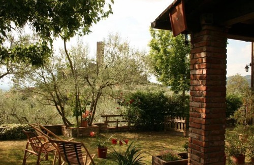 Montecchio Villa | Fully detached and fenced stone farmhouse with an outside porch. Garden equipped with table, chairs,