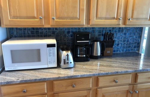 Riverside House | GORGEOUS lake view, large yard w/firepit, rooftop solar, 4 min drive to beach