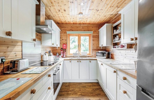 Menai Bridge Ski Chalet | Ground floor: Spacious open plan lounge, kitchen, dining area with log burner.