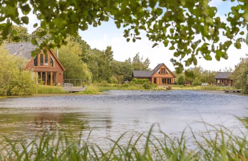 Menai Bridge Ski Chalet | Ground floor: Spacious open plan lounge, kitchen, dining area with log burner.