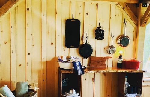 Boscawen RV Rental | Handcrafted, off-grid, no electricity-rustic-lux camping cabin w/running water.