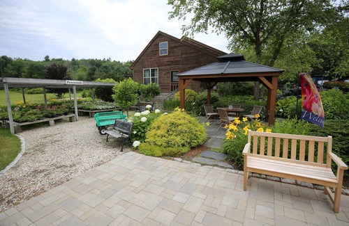 Lanesborough House | Hearts Desire is a furnished whole house in a small, colorful garden center.
