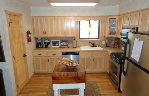 Mount Ida Cottage | Lake view two bedroom, two bath log-sided cottage with private hot tub overlooking Lake Ouachita. by RedAwning