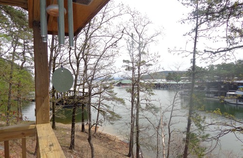 Mount Ida Cottage | Lake view two bedroom, two bath log-sided cottage with private hot tub overlooking Lake Ouachita. by RedAwning