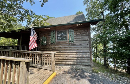 Mount Ida Cottage | Lake view two bedroom, two bath loft, log-sided cottage with private hot tub overlooking Lake Ouachita. by RedAwning