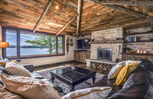 Presque Isle Cabin | Lakefront home on snowmobile trail with kayaks/SUP, fireplace, game room & AC