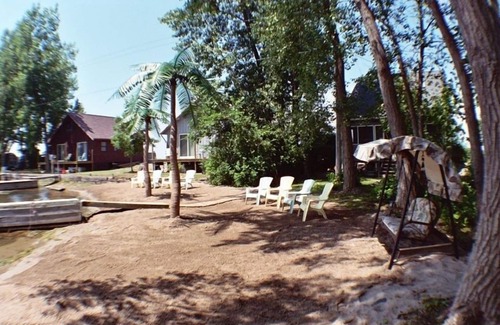 Wolcott Cottage | Lure Cottage, Right on the beech. Palm Trees, Free Motor Boat.