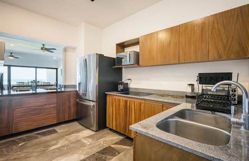 Ixil Apartment | Oceanfront retreat with private balcony, outdoor pool, and stunning views