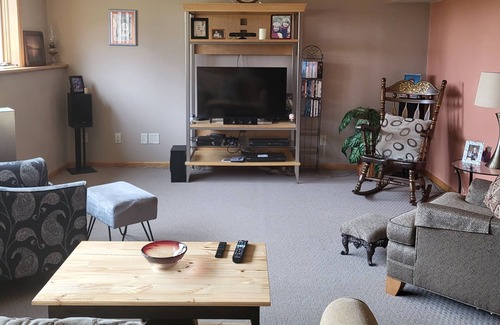 Pickett House | One bedroom and full bath in home 2 miles from EAA. Area with TV & refrigerator.