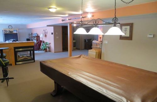 Pickett House | One bedroom and full bath in home 2 miles from EAA. Area with TV & refrigerator.