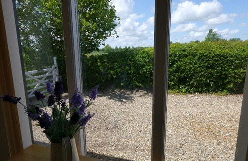 Alburgh House | One bedroom barn with open plan living area, private patio/garden,great sunsets