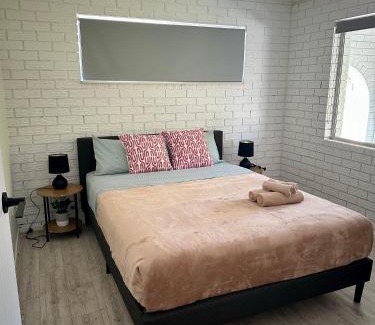 Gold Coast House | One bedroom with shared bathroom ground level of a two-story house