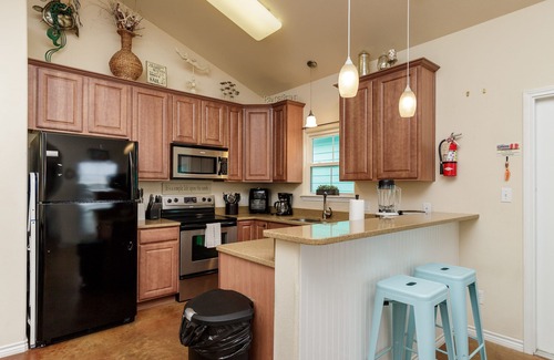 Corpus Christi Cottage | Pet-Friendly Retreat w/a Private Patio, Tropical Pool, & in a Great Location!