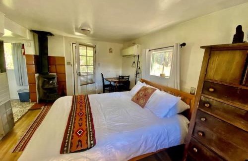 San Cristobal House | Petite Log Cabin on Organic Farm in New Mexico