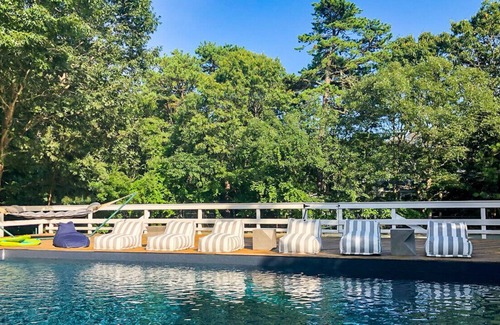 Quogue House | Post-Modern-style home with coastal-style bedrooms, an open-floor plan, a...