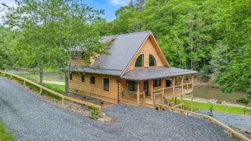 Warrensville House | Riverstead Cabin- Riverfront, Wrap Around Porch, Hot Tub & More