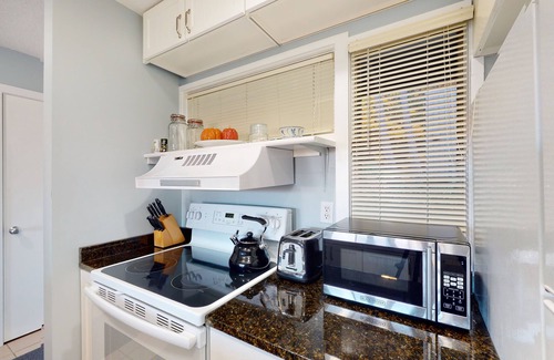 Maple City Condo | Riverview condo near the lake with beach access, fireplace, patio & cable
