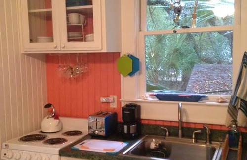 Folly Beach Cottage | Romantic, cozy cottage nestled amongst live oaks & palms, a block from beach.