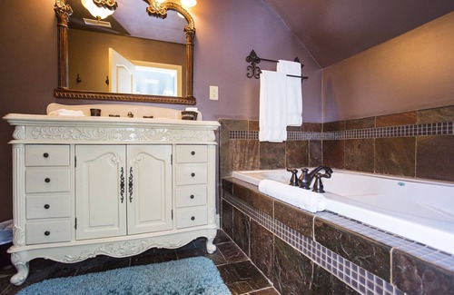 La Grange Bed & Breakfast | Room with a View King Luxury Suite with extra-large large soaking tub and a chaise lounge with a view of the pond.