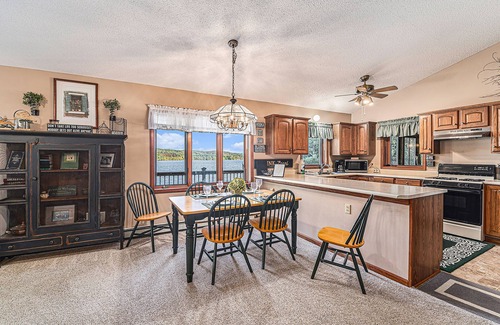 Bellaire House | Rustic lakefront home with large balcony, wood fireplace, grill, & washer/dryer