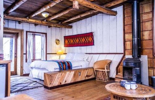 San Cristobal House | Rustic Log Cabin on Eco-Friendly Farm near Taos, New Mexico