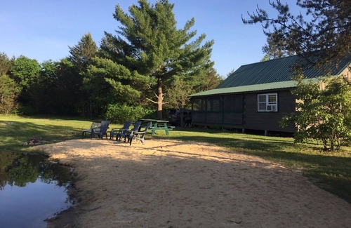 Sparta Cabin | Secluded family-friendly log cabin with swimming pond. Charm, comfort.