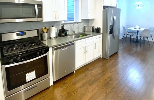 Irving Park Apartment | Sleek 3BR: Minimalist Style, Fire Pit, 65-inch TV, & Tech-Ready!