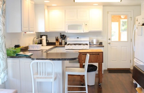 Negaunee Cottage | Summer fun! Hot tub, firepit, kayaks, water trampoline!