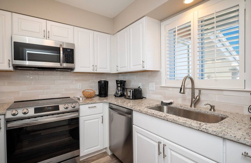Caswell Beach Condo | Swept Away: Modern Oceanfront Condo Steps from Community Pool