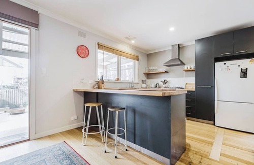Kensington House | Tangerine Gleam Cheerful Inner City Family Abode