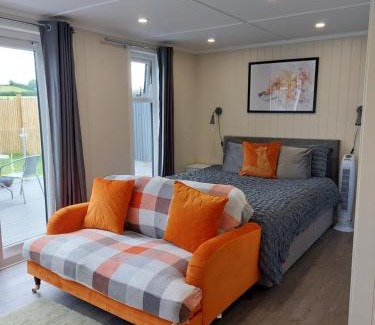 Amroth Apartment | The Den - Modern cabin with wood burning stove