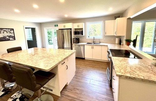 Lion's Head Cabin | This bright and spacious retreat blends modern comfort with cozy cottage charm. Featuring a fully equipped kitchen, multiple cozy bedrooms, stylish bathrooms, and inviting living spaces with a wood-burning fireplace.