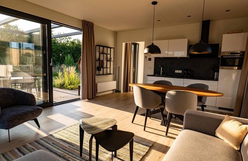Lattrop House | This holiday home with a private sauna and hot tub features a cozy, homely living room with an open kitchen, 2 bedrooms, and a spacious outdoor area
