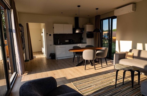 Lattrop House | This holiday home with a private sauna and hot tub features a cozy, homely living room with an open kitchen, 2 bedrooms, and a spacious outdoor area